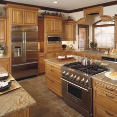 a kitchen with wooden cabinets and stainless steel appliances