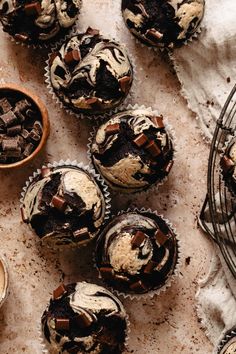 several cupcakes with chocolate and marshmallow toppings