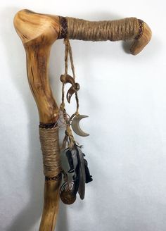 an animal's claw hanging from a rope with other items attached to the wall