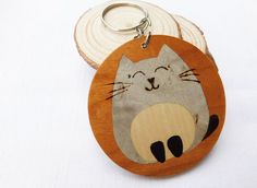 a wooden keychain with an image of a cat on it