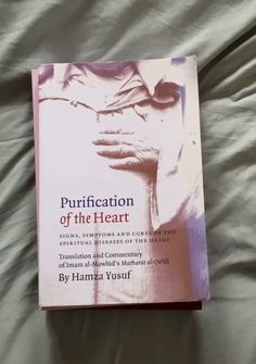 a book about purification of the heart on a bed