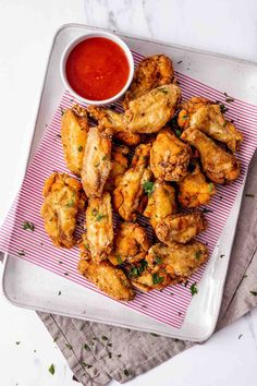 chicken wings on a plate with dipping sauce