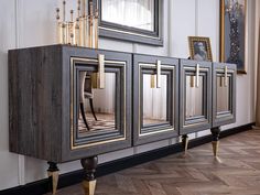 the sideboard is made out of wood and has mirrored doors