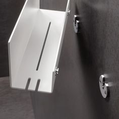 a white sink mounted to the side of a wall