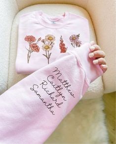 This Personalize Mom Gift from Kids with names heart on sleeve makes an absolute perfect Mother's Day Gift for any Mom! This Custom Birth Month Flower Gift comes with your choice of Birth month flowers printed on your custom Mom shirt or Mama Sweatshirt, along with the beautiful flowers, her children's names will be custom printed onto the sleeve coordinating with the birth months of each child. Such a precious and thoughtful Mother's Day Shirt that she will use and love for years to come! Due t Heart On Sleeve, Granny Gifts, Gigi Gift, Unique Gifts For Mom, Birth Month Flower, Mother In Law Gifts, Personalized Mother's Day Gifts, Kids Names, Gardening Shirts