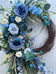 a wreath with blue flowers and greenery