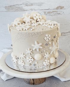 a white frosted cake with snowflakes on it