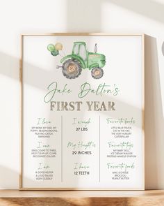 a green tractor first year printable on a white wall next to a wooden shelf