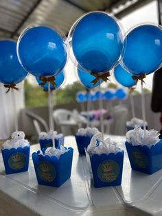 blue balloons are on top of small cupcakes