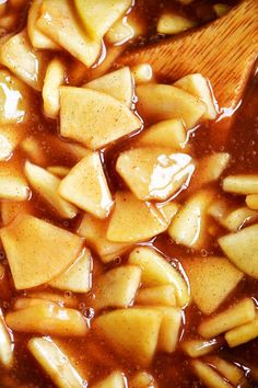 the food is being prepared and ready to be cooked in the pot or oven with wooden spoon