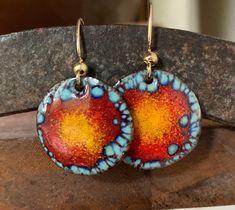 Beautiful bohemian enamel earrings with bold colors.  The gorgeous bold colors of blues,reds and oranges make a statement. it will add a spark of fun in your day. Many layers of enamel are applied, some are transparent and others opaque which gives some depth to the piece,a special enamel technique is applied to give a bohemian look. The earrings are torch fired at a very high temperature of around 1500F. Enamel is powdered glass fused to a metal, in my case,I use a copper base. The earwire is made of brass which is hypoallergenic and very comfortable to wear. The total length of the earrings is 1 1/4 inch. The disc measure 13/16 inch. Thank you for visiting my shop and do not hesitate to contact me if you have any questions. Please note that I am based in Costa Rica and the shipping takes Enameled Earrings, Enameled Jewelry, Abstract Ideas, Enamel Art, Earrings Chandelier, Polymer Crafts, Brass Hook