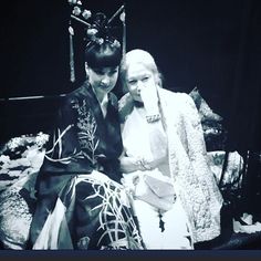 two women dressed in traditional japanese clothing sitting next to each other and posing for the camera