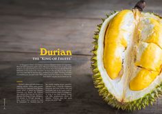 durian the king of fruits is cut in half and displayed on a wooden table