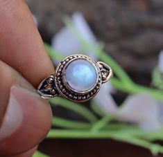 This beautiful stacking ring features a genuine moonstone gemstone in a Round design. Our blue fire moonstone is cut in Round brilliant cut, which has an intense blue color with a hint of red undertones, and will add an elegant touch to any look. This makes the perfect engagement ring or bridal set, or can be worn as an everyday piece. The Product Specification Are As Below : Stone - Moonstone Stone Shape - Round About Gemstone- Moonstones' healing properties help against nosebleeds, headaches, sunstroke, and epilepsy. These gemstones are also believed to help with the menstruation cycle and increase fertility. Unique design of this ring will make a special attraction for the wearer. Your order will dispatch within 2 days and you will receive it asap. For more Exciting and beautiful rings Hippy Gifts, The Perfect Engagement Ring, Moonstone Stone, Rainbow Moonstone Ring, Small Jewelry Box, Natural Rainbow, Blue Fire, White Band, Round Design