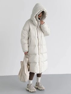 Material: 50% Polyester, 50% Nylon Step into winter with style in our Loose Hooded Long White Winter Jacket. This jacket combines the comfort of a loose fit with the elegance of a long silhouette, ensuring you stay cozy and fashionable. Embrace the season with confidence, wrapped in the warmth and versatility of this chic white winter jacket. Elevate your winter wardrobe with this timeless piece. Care: Machine Wash: Wash the jacket in cold water on a gentle cycle to preserve the fabric and color White Winter Jacket, Warm Coats, Autumn Winter 2022, Duck Down Jacket, White Duck, White Ducks, Winter 2022, Warm Coat, Duck Down