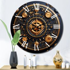 a black and gold clock sitting on top of a wooden table next to a vase