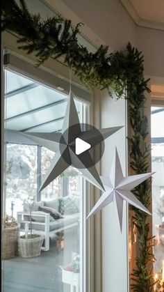 an ornament hanging from the side of a window next to a christmas tree