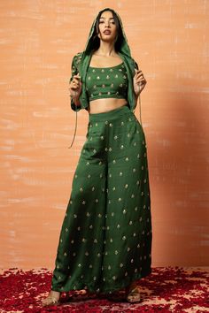 Mehendi green hoodie with bead, thread and sequin hand work. Paired with embroidered pants and deep U neck top.
Component: 3
Pattern: Machine Work
Type Of Work: Bead, Thread and Sequin Work
Neckline: Top: U Neck
Sleeve Type: Hoodie: Three Quarter, Top: Sleeveless
Fabric: Modal Silk
Color: Green
Other Details: 
Front zip and drawstring closure
Attached lining
Weight (in kg): 1.5
Occasion: Sangeet,Cocktail,Haldi and Mehendi - Aza Fashions Plazo Outfits, Co Ords Outfits, Raw Silk Lehenga, Special Dress, Diwali Special, Palazzo Set, Embroidered Pants, Designer Jumpsuits, Green Hand