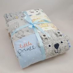 a baby blanket with a bear on it and blue ribbon tied around the edges that says, little prince