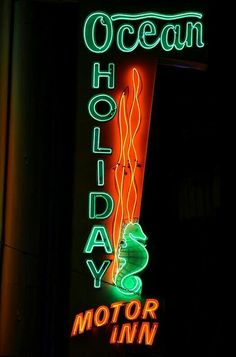 a neon sign that reads ocean holiday motor inn