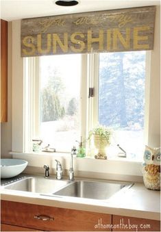 a kitchen sink under a window with the words sunshine on it and an owl statue