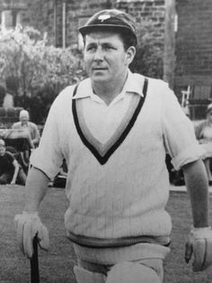 an old black and white photo of a man holding a baseball bat in his hand