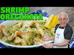 an old man holding a plate of food with shrimp and broccoli in it