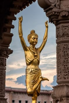 a golden statue in front of a building