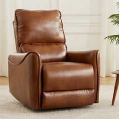 a brown recliner chair sitting on top of a rug