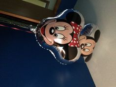 a mickey mouse balloon hanging from the ceiling