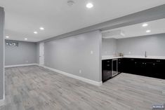 an empty room with gray walls and wood floors