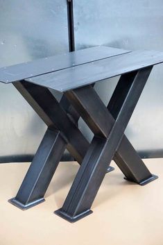 a metal table sitting on top of a wooden floor