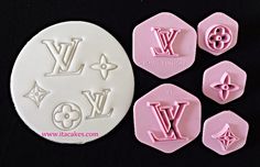 four wax stamps with the word louis written in white and pink on them, sitting next to each other