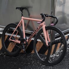 a pink bike parked next to a train