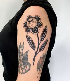 a woman with a flower tattoo on her arm