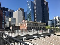 there are many tall buildings in the city and one building has a fence around it