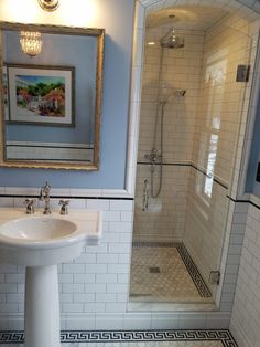 a white sink sitting under a mirror next to a shower