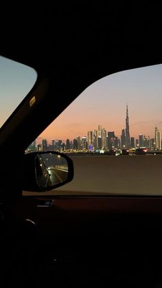 a view of the city from inside a car at sunset or dawn, looking out to sea