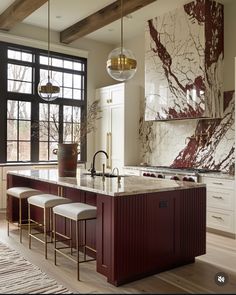 a large kitchen with marble counter tops and an island