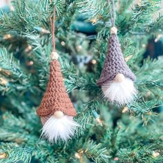 two crocheted gnome ornaments hanging from a christmas tree