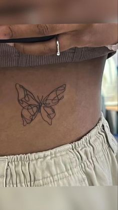 a woman's stomach with a butterfly tattoo on her belly and the bottom part of her abdomen