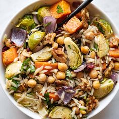 a white bowl filled with vegetables and rice