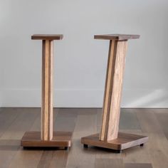 two wooden stands sitting on top of a hard wood floor