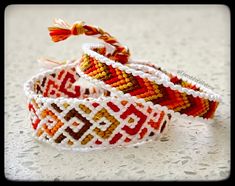 two colorful bracelets sitting on top of a table