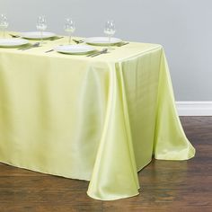 the table is set with four empty wine glasses on it, and there are no place to sit