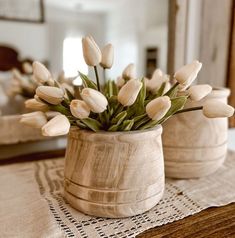 white tulips in a wooden vase on a table