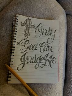 a notepad with the words only god can judge me written on it next to a pencil