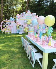 a table set up with balloons, cake and other decorations for a princess birthday party