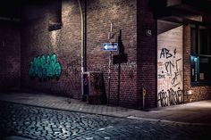 a brick building with graffiti written on it