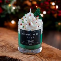 a christmas tree candle sitting on top of a wooden table